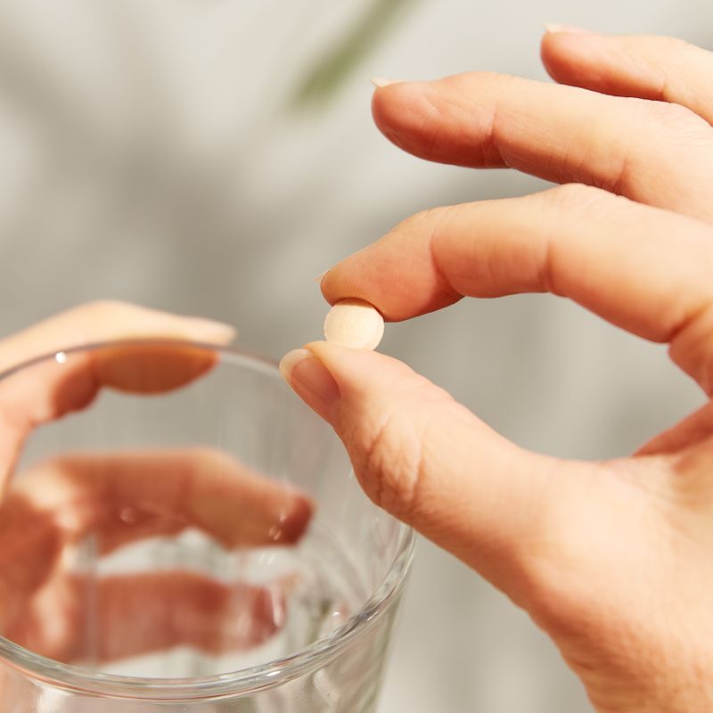 Solgar MenoPrime Menopause Tablet in a person's hand 