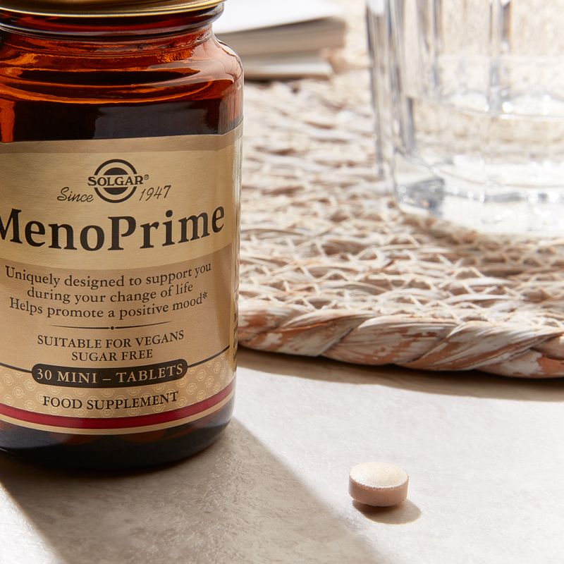 Solgar MenoPrime Menopause Tablets in a glass jar on a table 