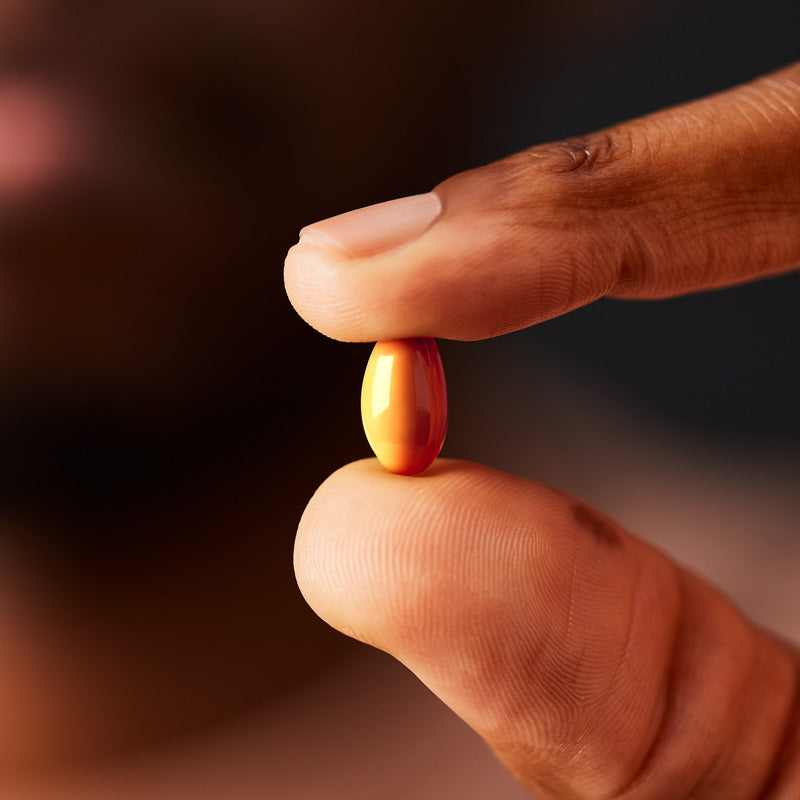 Solgar Fish Gel Ubiquinol 100 mg Softgel in a person's hand